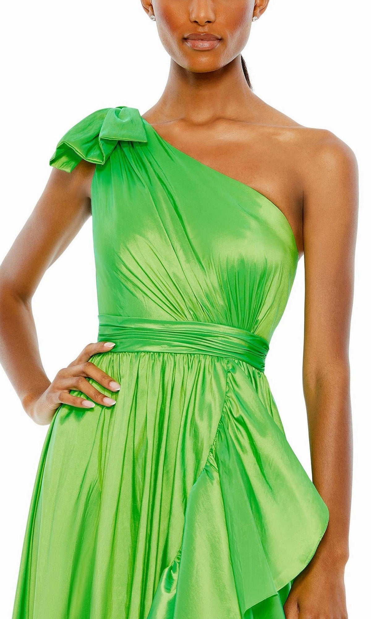 A woman wearing the Mac Duggal Long Formal Dress 68027, a shiny bright green one-shoulder gown with a gathered waist, asymmetric A-line silhouette, and bow accent on the left shoulder.